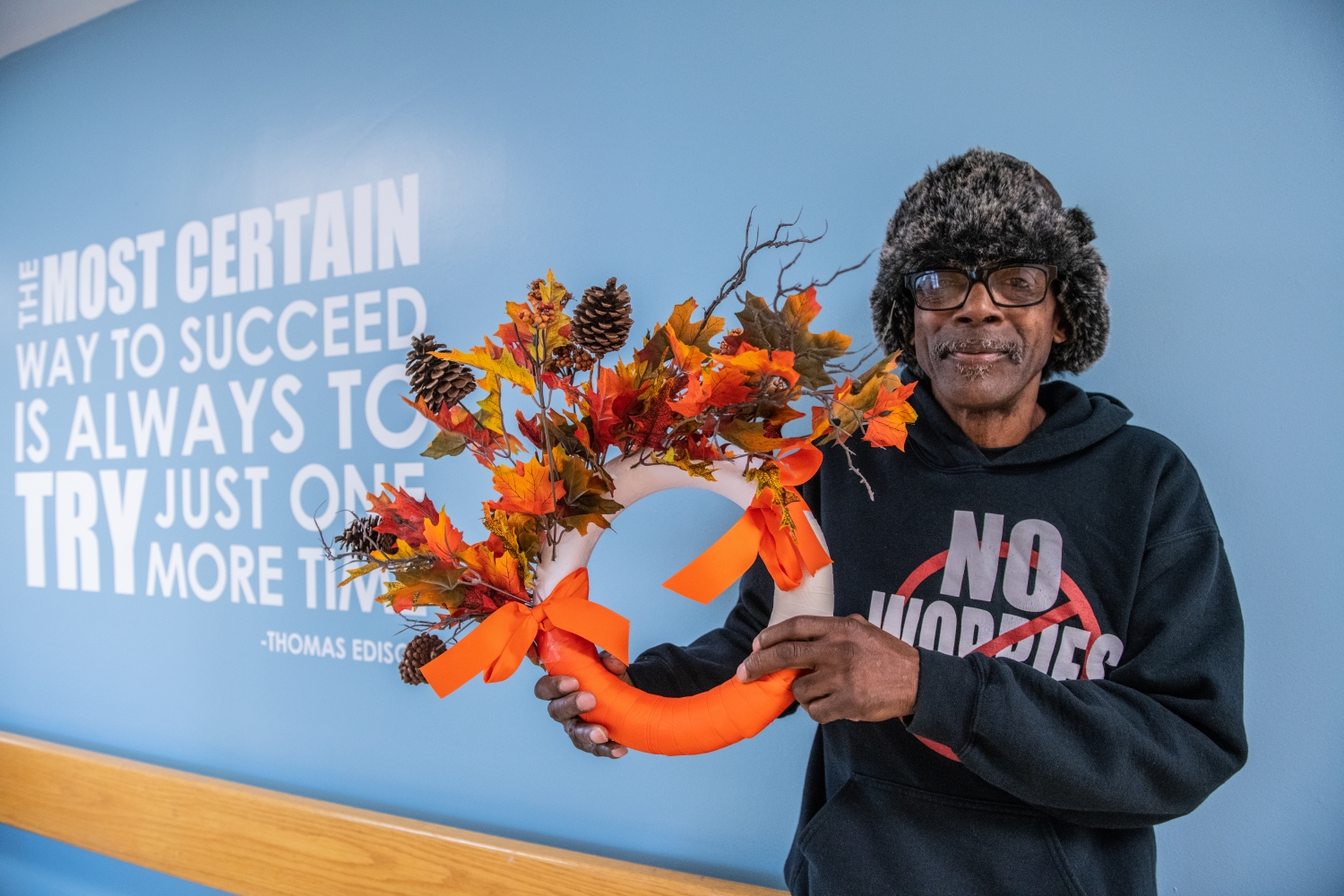 participant holding up a fall craft