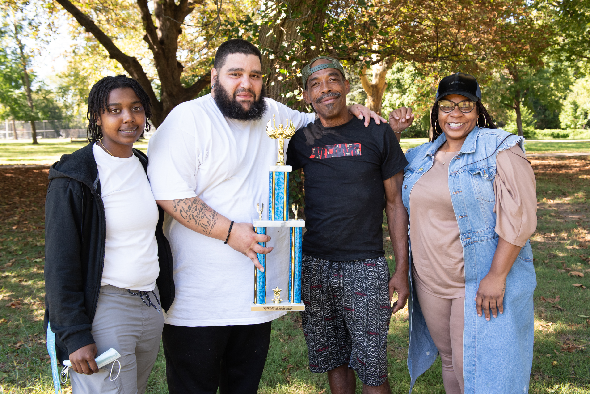 participants and staff holding the trophy outside at our annual cookout