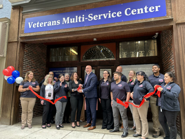 vmc staff in front of the grand opening of a new center in harrisburg,pa
