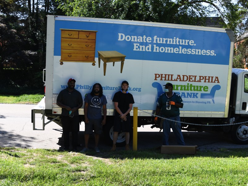 four men standing in front of the PFB truck