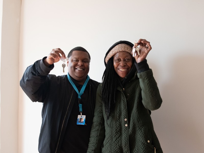 staff and participant holding up keys