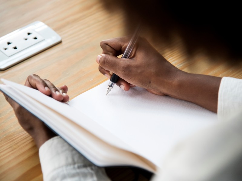 woman writing in a notebook