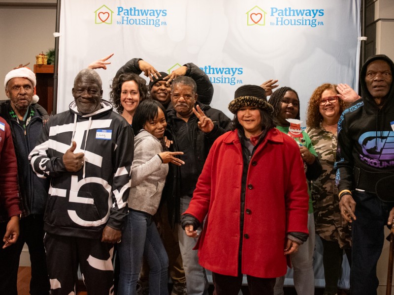 Team 3 staff and participants in front of a Pathways to Housing PA backdrop