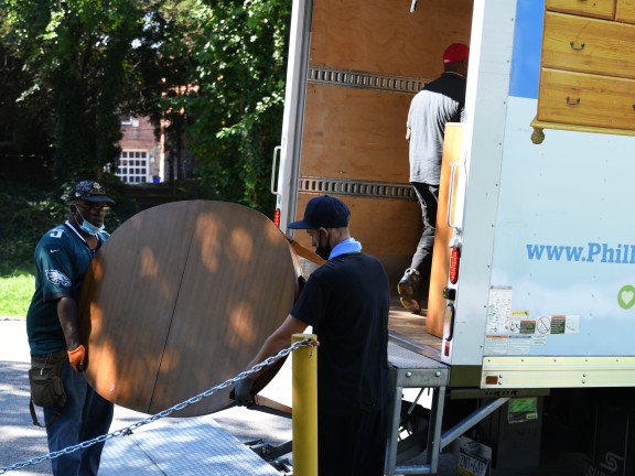 people loading furniture into a van