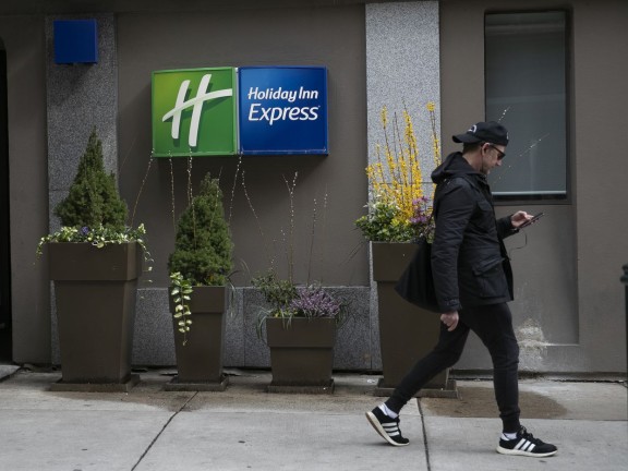 man walking past the Holiday Inn Express Center City