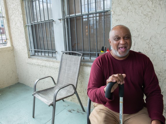 man smiling on porch