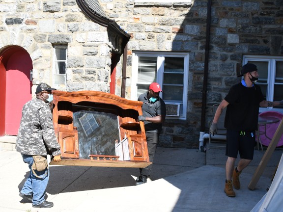 three men loading furniture into a truck