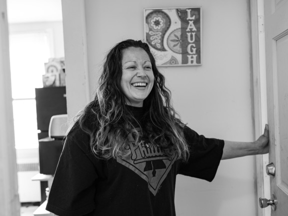 participant smiling in her apartment, black and white photo