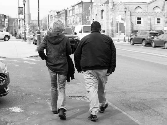 two people walking down a city street