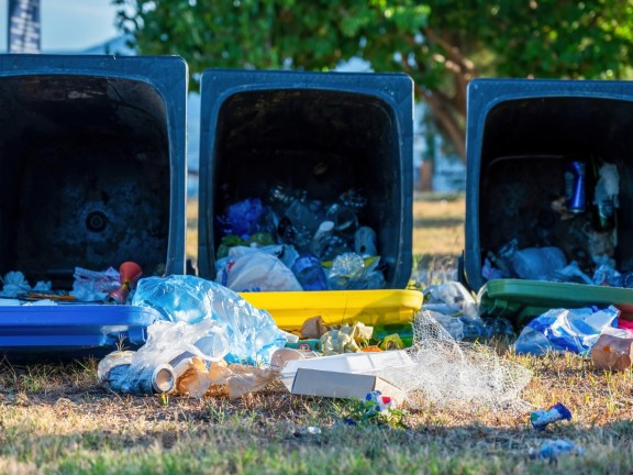 dropped-dumpsters-with-fallen-out-trash-ground.