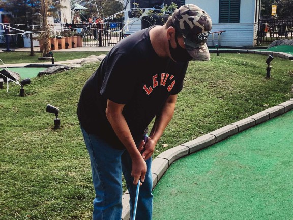 person playing mini golf