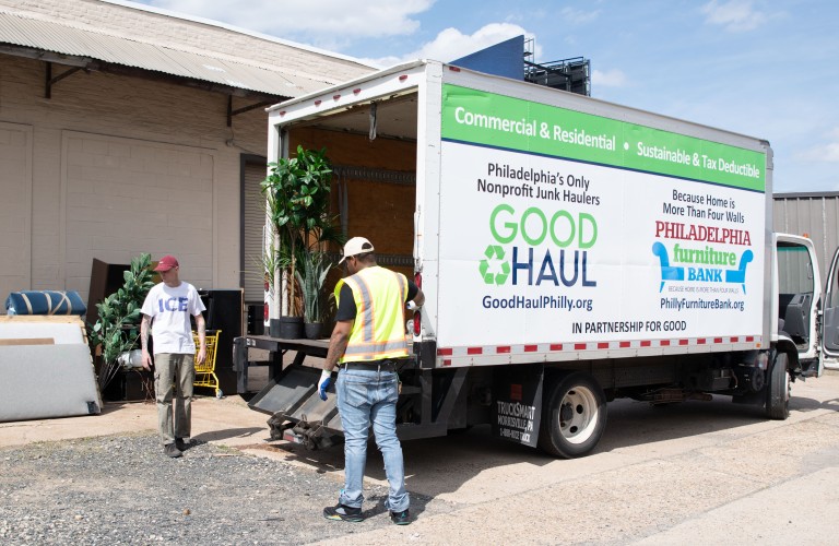 good haul workers near a truck