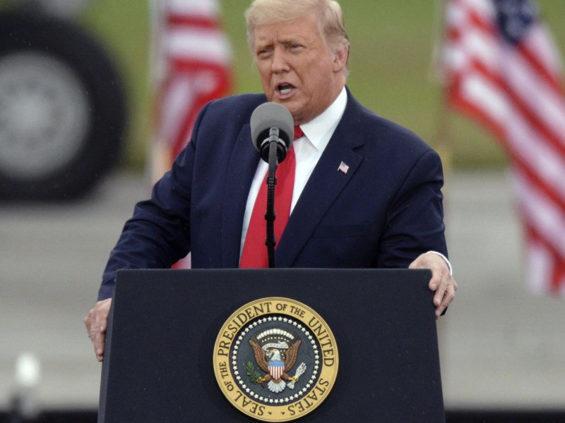 Former President Donald Trump speaking at a podium
