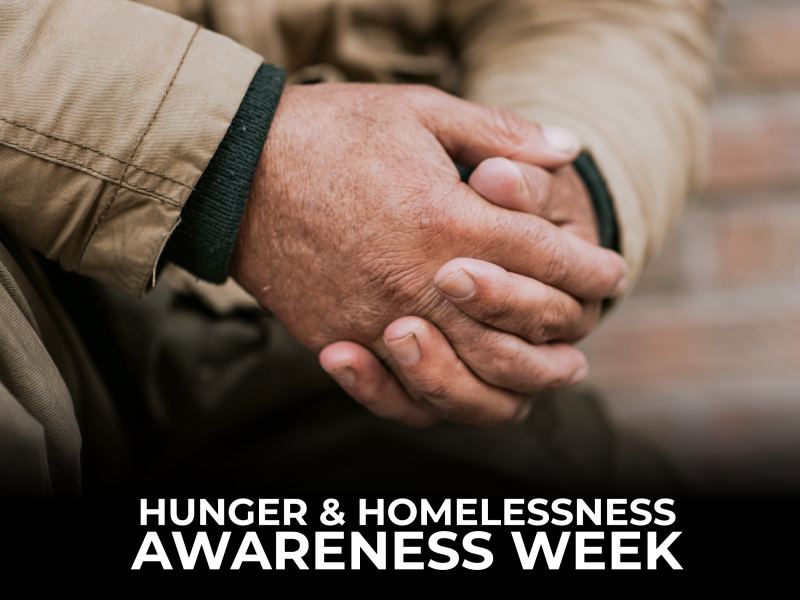 hunger and homelessness awareness week text in front of two hands clasped together