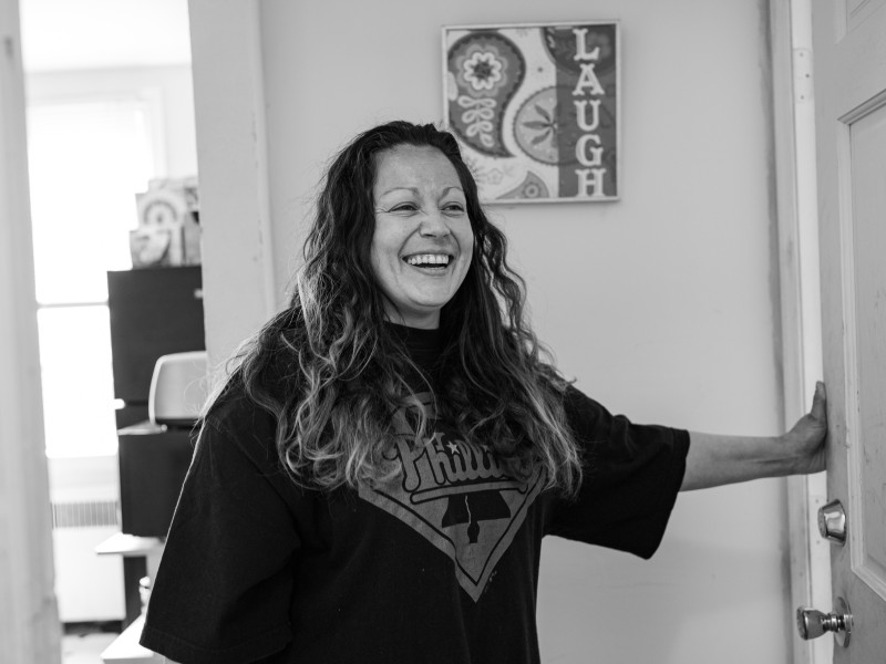 participant smiling in her apartment, black and white photo
