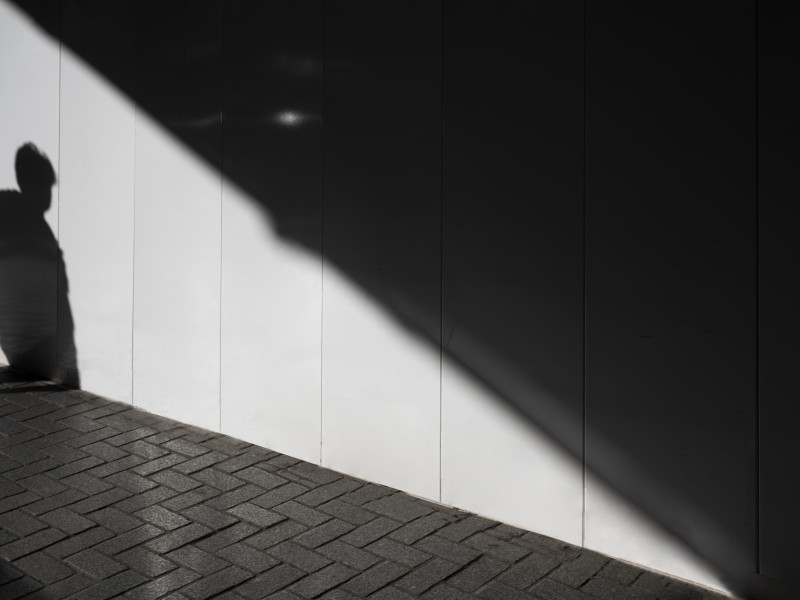 silhouette of person against gray concrete wall