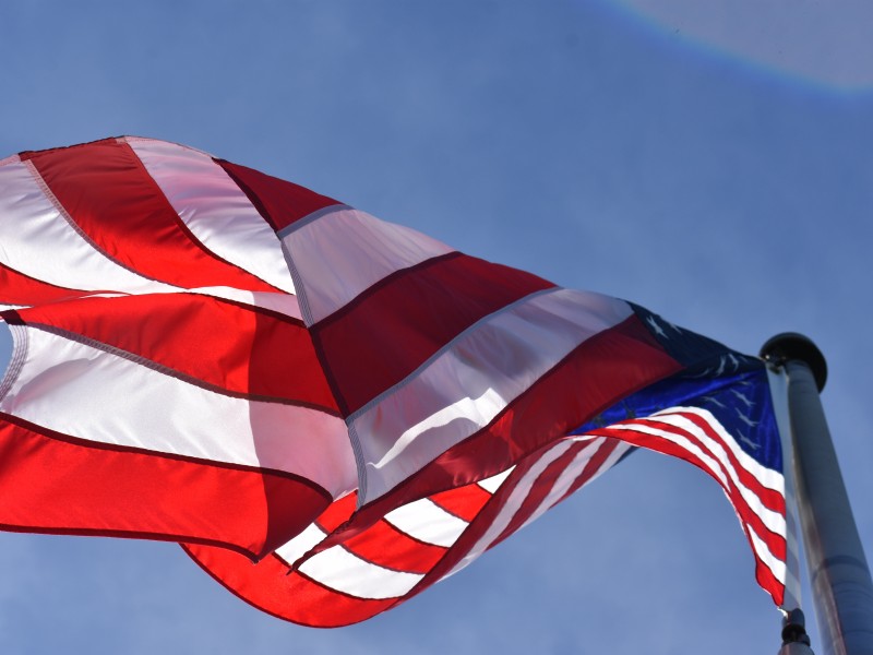 american flag against a blue sky