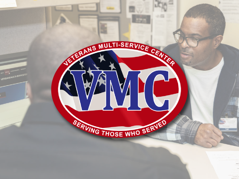 VMC logo centered on a stock photo of two people talking