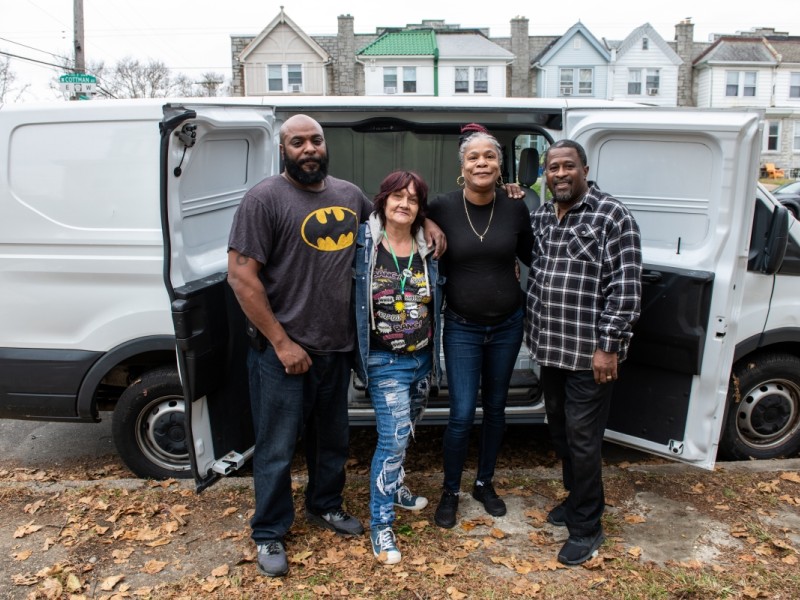 4 people standing in front of a van after move in