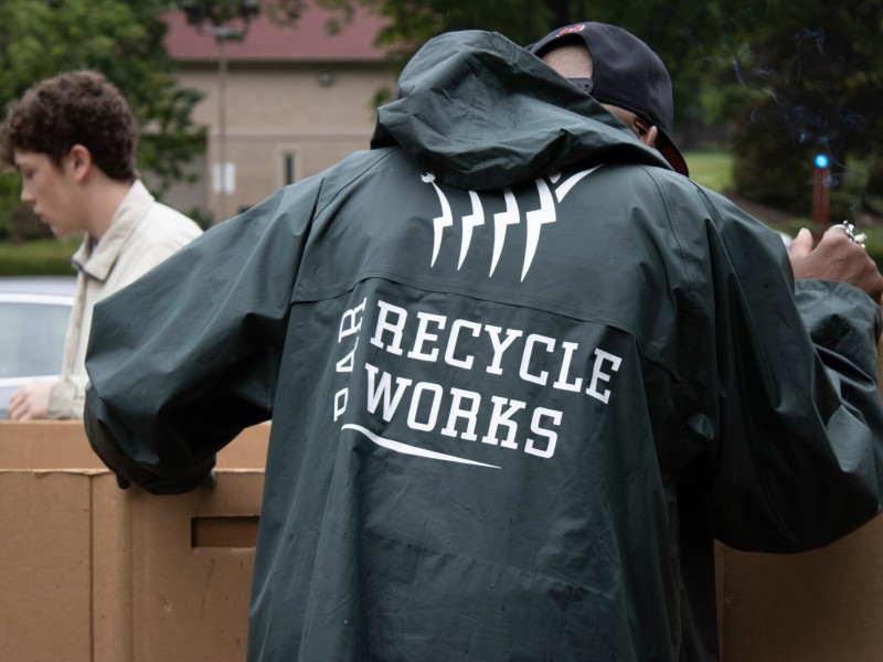 person with rain jacket on that has PAR-Recycle works logo displayed