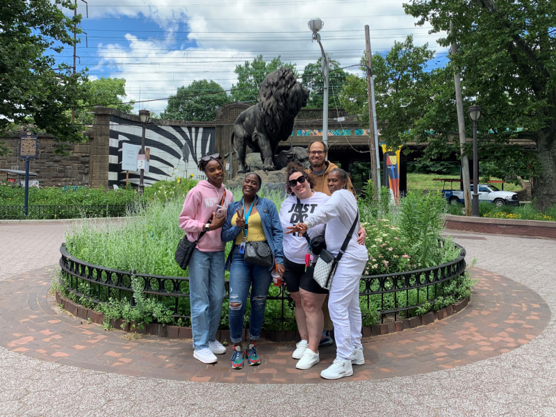 a group of participants and staff in front of a statue at the Philly Zoo