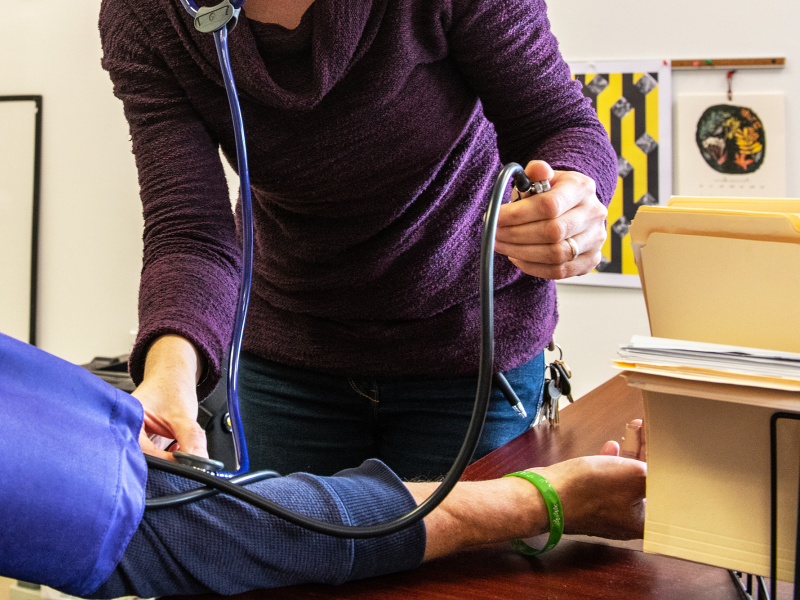 nurse taking participant blood pressure, faces are not in frame
