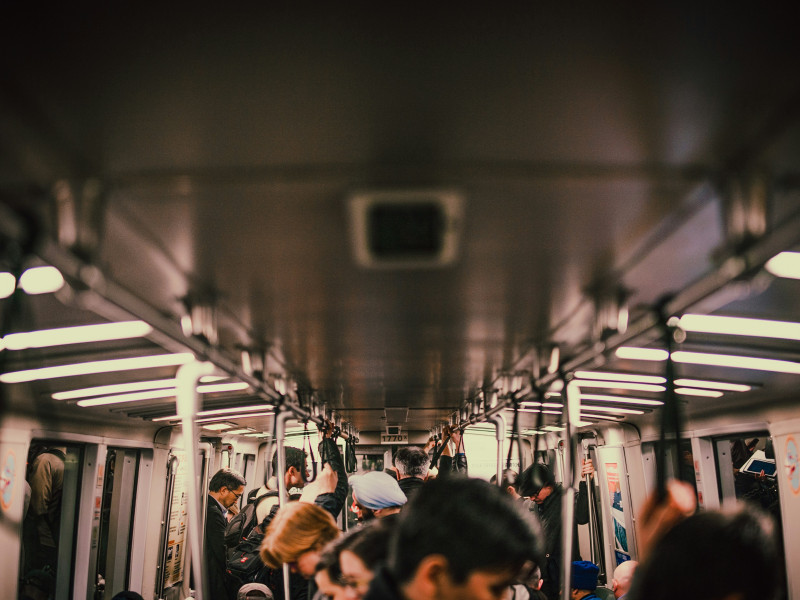 people, indistinct, on a subway train, mostly ceiling