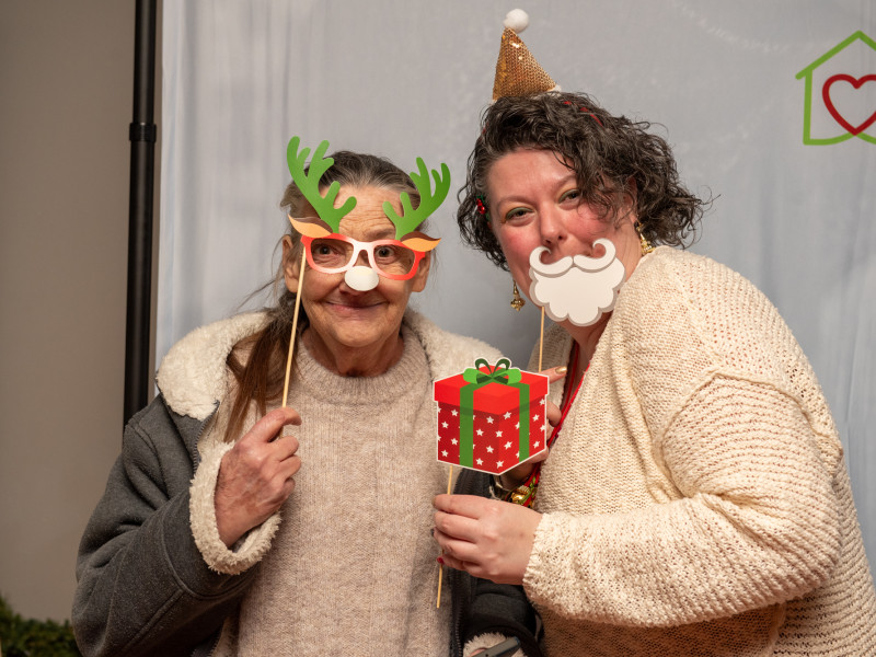 photo of deb and christine at 2023 holiday party with holiday props
