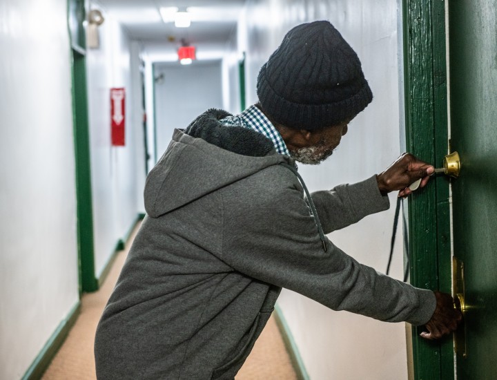 man opening his apartment door