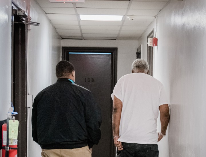 two men walking down a hallway