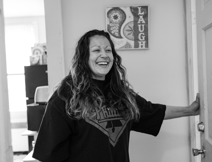 participant smiling in her apartment, black and white photo