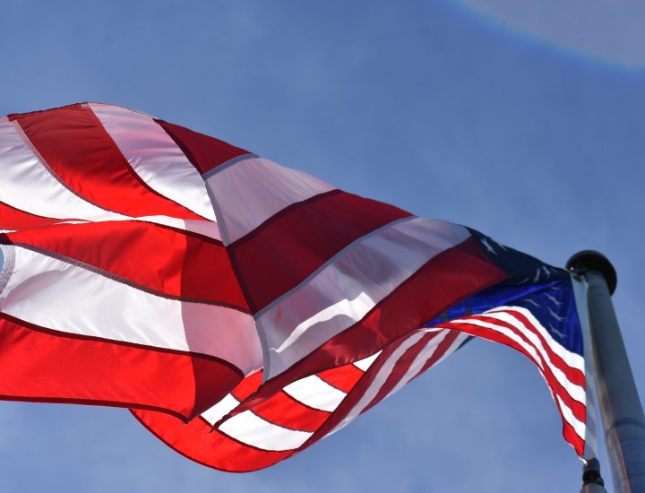 american flag against a blue sky