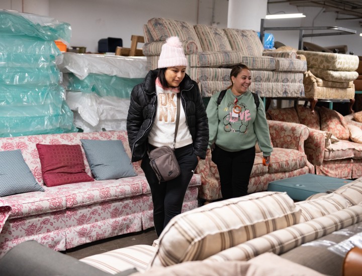 client and case manager in the furniture bank picking furniture near the sofas