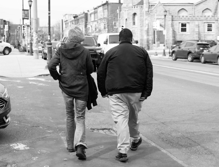 two people walking down a city street