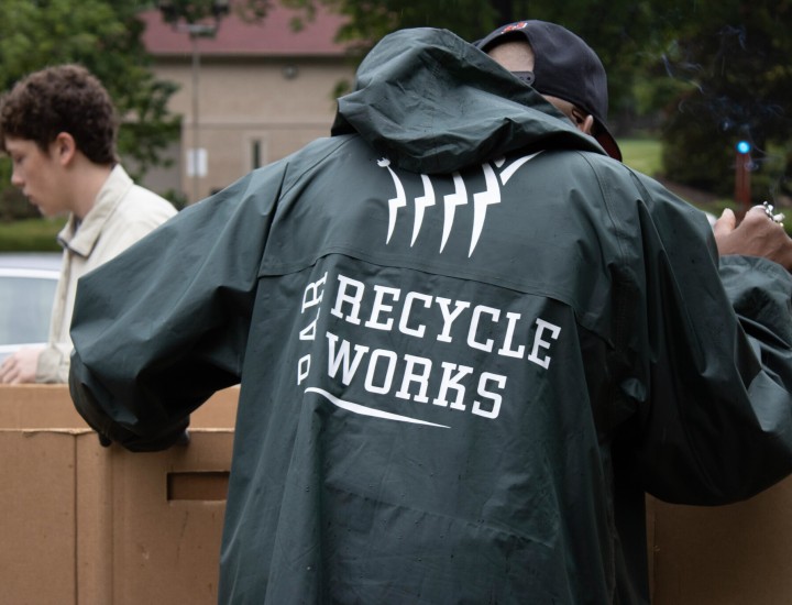 person with rain jacket on that has PAR-Recycle works logo displayed