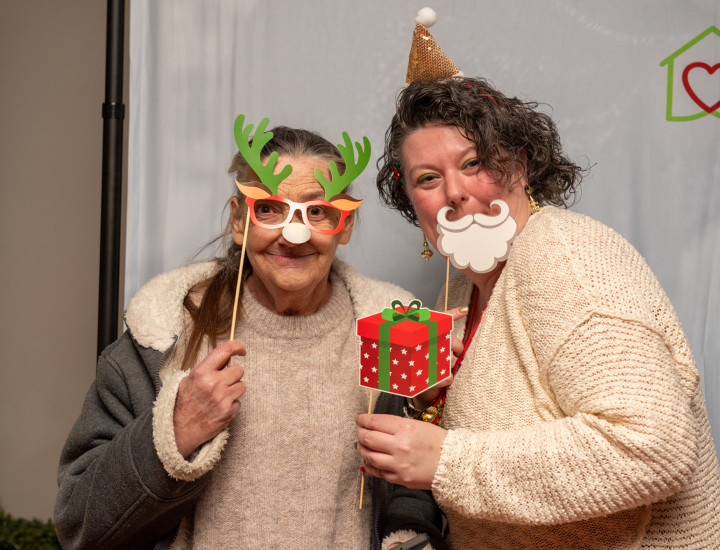 photo of deb and christine at 2023 holiday party with holiday props